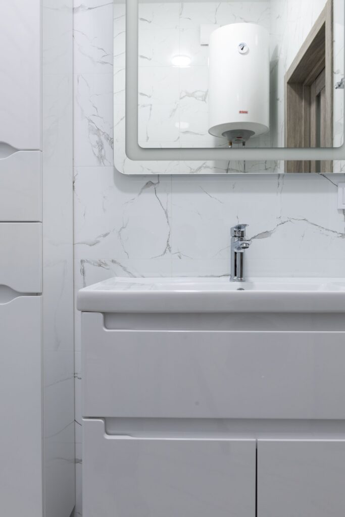 A bathroom basin and mixer tap under a mirror