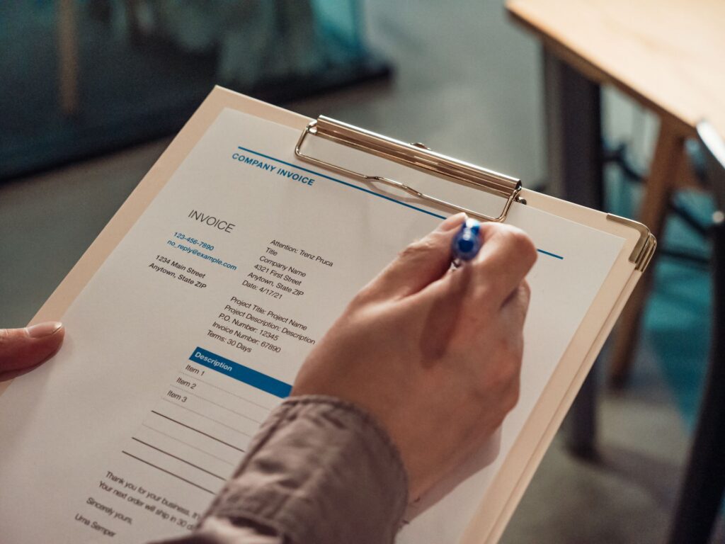 A checklist being filled in on a clipboard