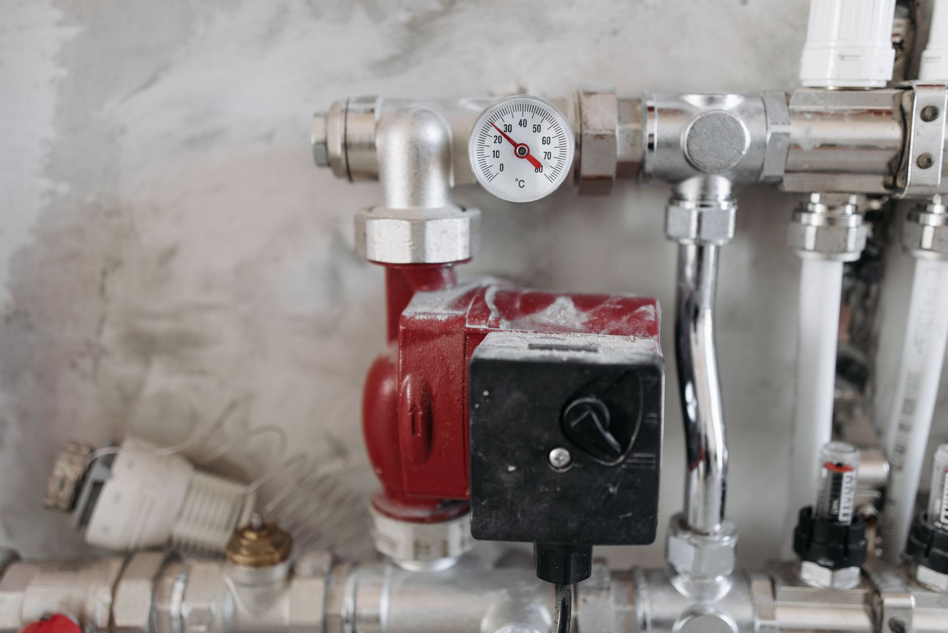 A plumbing manifold with a pressure gauge and isolation valves