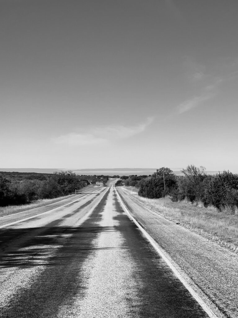An open road running through flat Texas country