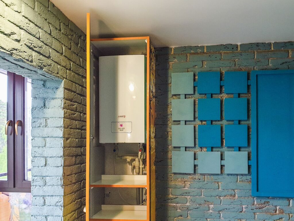 A wall mounted water heater installed in a utility space