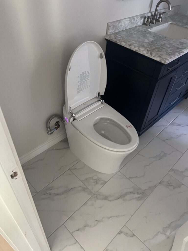 A newly installed toilet in a finished bathroom